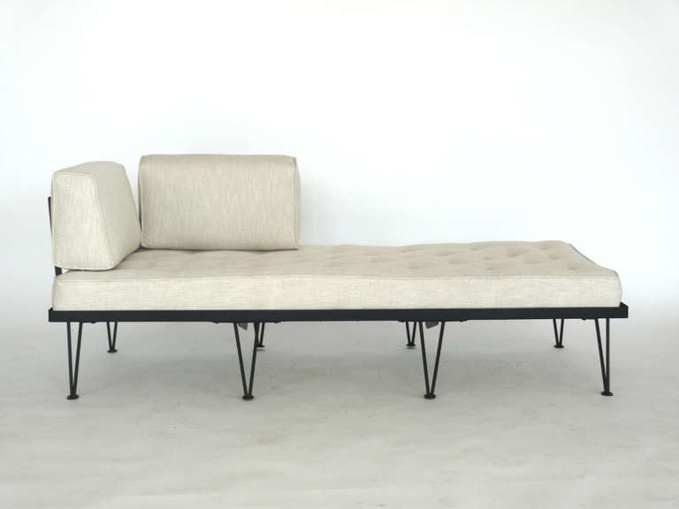 Lovely daybed designed by Frederick Weinberg. Newly upholstered cushions in heavy oatmeal colored linen. Rest on solid black iron frame with hairpin legs. Side handles are fully adjustable to move pillows around edges and may be completely removed
