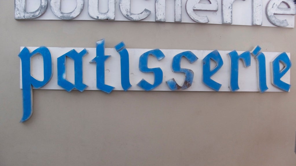 Fantastic metal storefront Patisserie letters from France. Blue painted letters with a great patina and chipping to the paint. Letters hang freely and can be rearranged to your liking. 