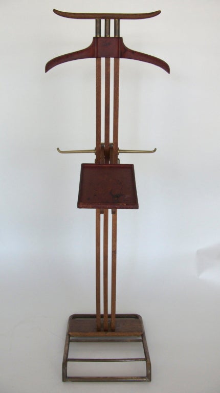 Iconic valet by Paul Dupre Lafon for Hermes, Paris.  Deep red leather, oak frame, and brass base and accents.  Stamped 