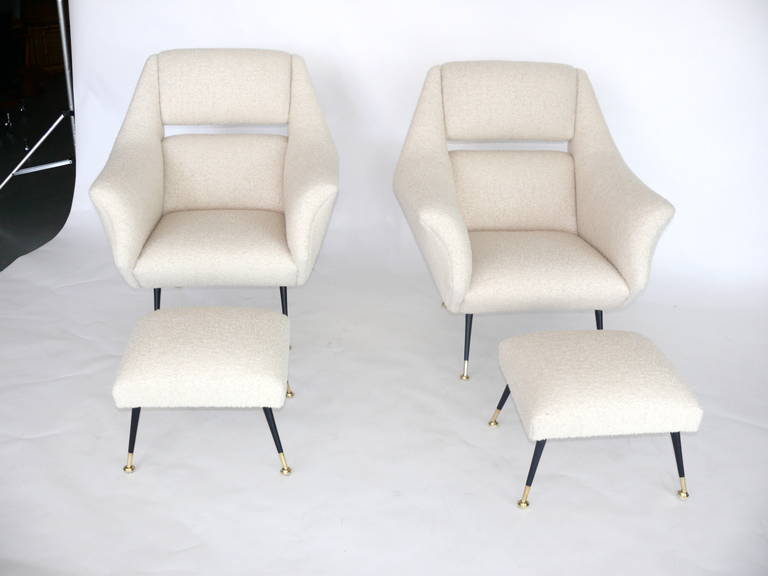 Exquisite pair of Italian club chairs newly upholstered in a wool boucle. Bases are original and in excellent vintage condition. Matching ottomans complete the set. Great lines and classic design. Ottoman measurements are 17.5