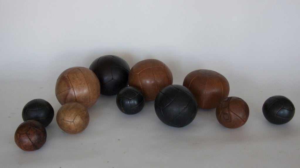 Wonderful collection of French leather medicine balls ranging in size and color. Beautiful patina and detailed stitching to leather. Great decorative objects for display! 

Priced individually according to size:
Extra Large - 12.5