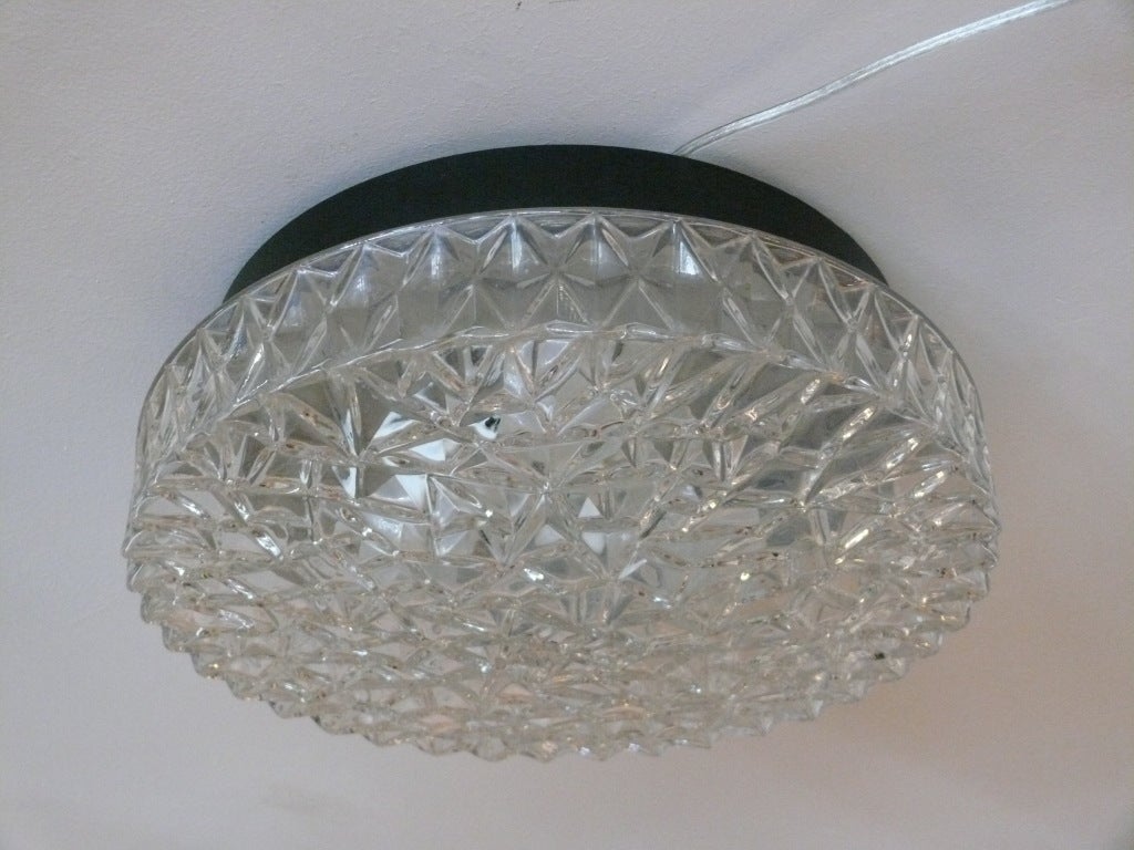 Great circular glass flush mount with thick clear glass with triangular formed textured surface. Glass hangs from deep black circular fixture. Newly re-wired.