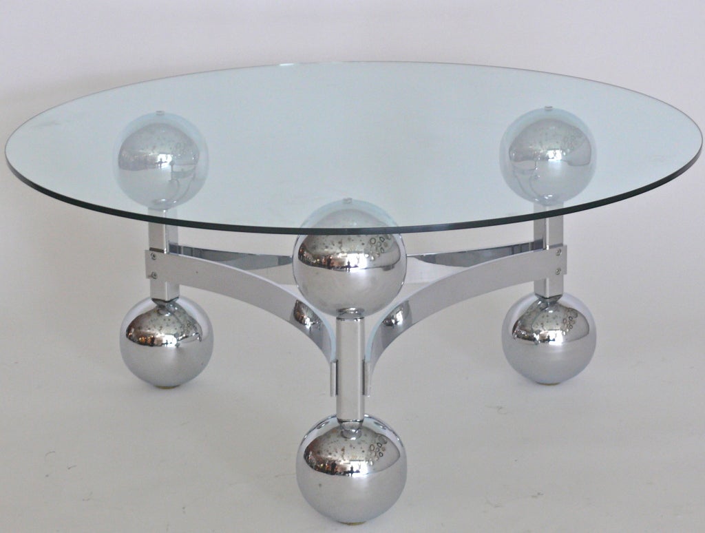 French chrome coffee table made of 6 large chrome orbs vertically stacked between chrome beam legs. Curved chrome supports create triangular and sputnik design.