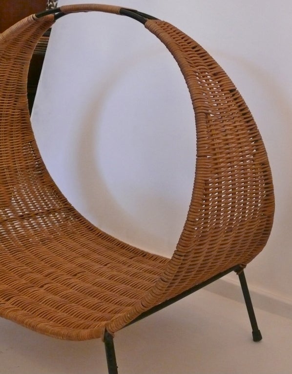 Great large scale iron and woven wicker log holder. Beautiful weave creates wide ring perfect for resting logs. Sits on black iron frame with wrapped rattan detail on handle. Low, modern and sleek design. Also great for magazines!