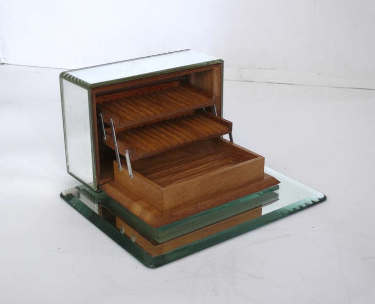 Fantastic mirrored Art Deco cigarette box. Box opens to reveal two wooden tiers designed for cigarettes and one bottom level of storage. Great scale and can be beautifully displayed closed or opened.