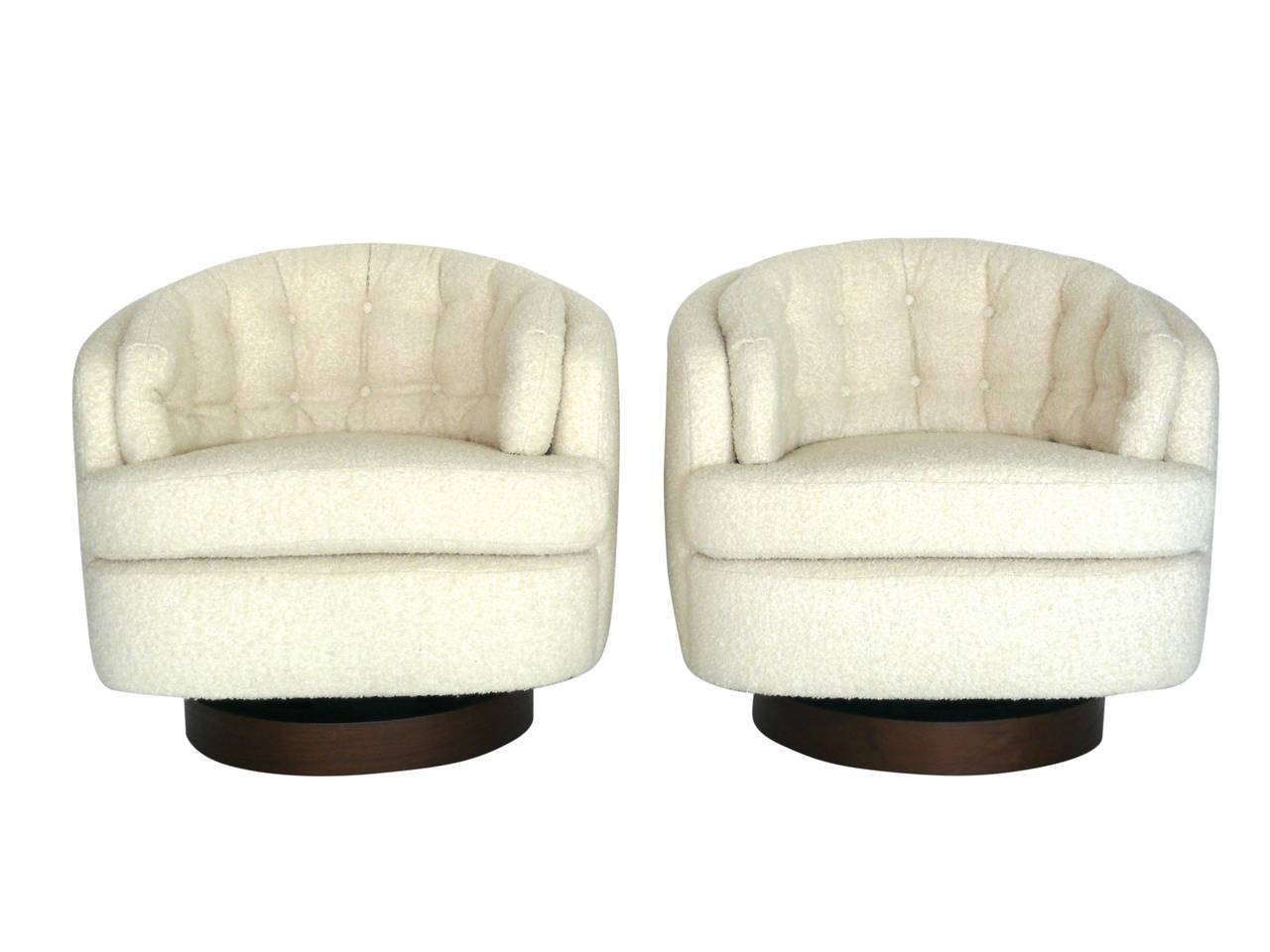 Classic pair of vintage swivel chairs by Milo Baughman for Directional. Round tub chairs with tufted biscuit back cushion. Newly reupholstered in a wool bouclé fabric. Base has a swivel and tilt mechanism. Very rare. Perfect for the home or office.