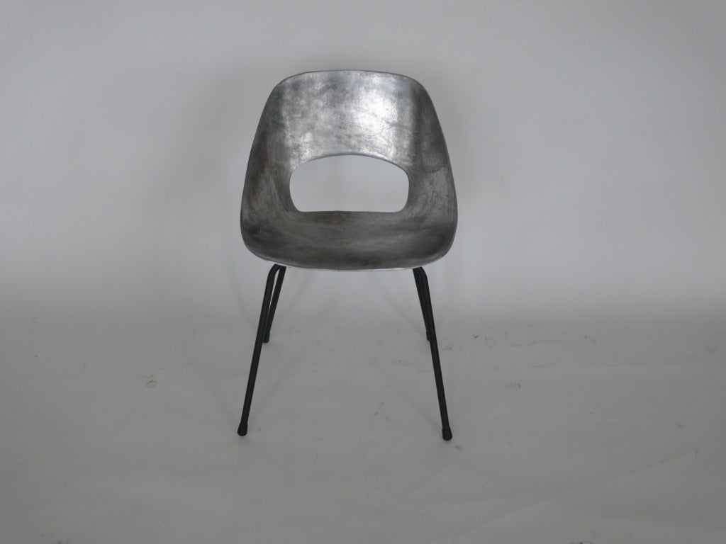 Incredible set of cast aluminum chairs by Pierre Guariche. Sculpted and curved aluminum seat with cut-out sits on sleek 4 leg black metal base. Sold in a set of 4. Incredible as dining chairs.