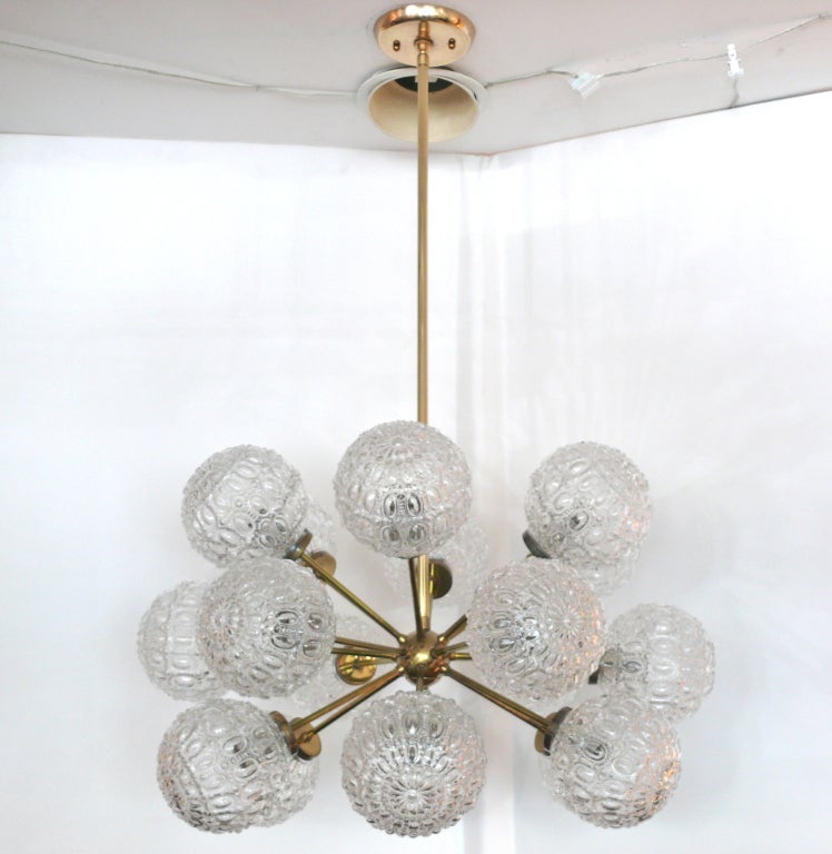 Impressive large scale sputnik chandelier with multiple clear textured glass globes stemming from brass ball and arms. Newly re-wired.