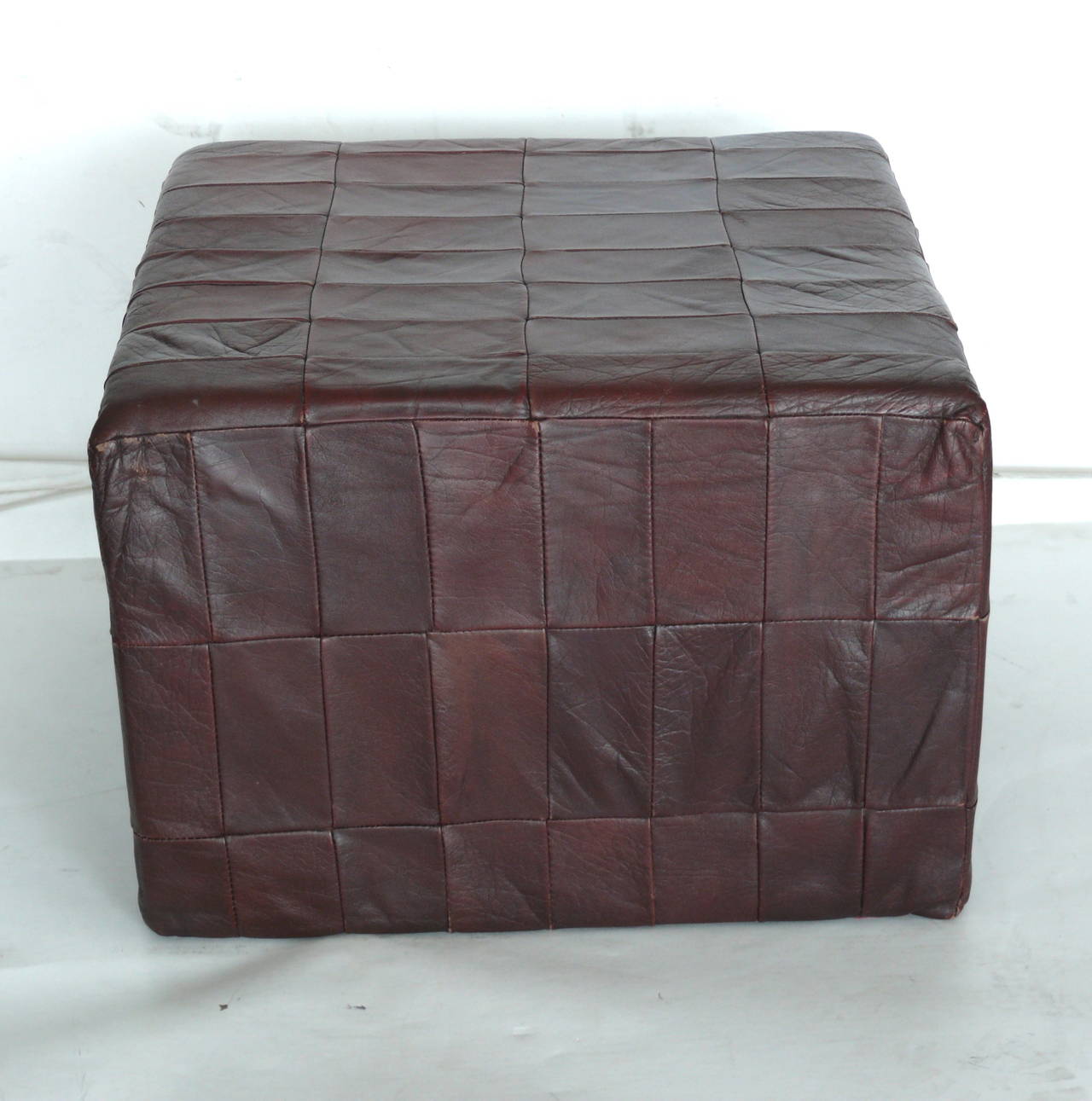 Original patchwork leather ottoman by De Sede, circa 1970s. Beautifully broken in leather with great patina. Great vintage condition.