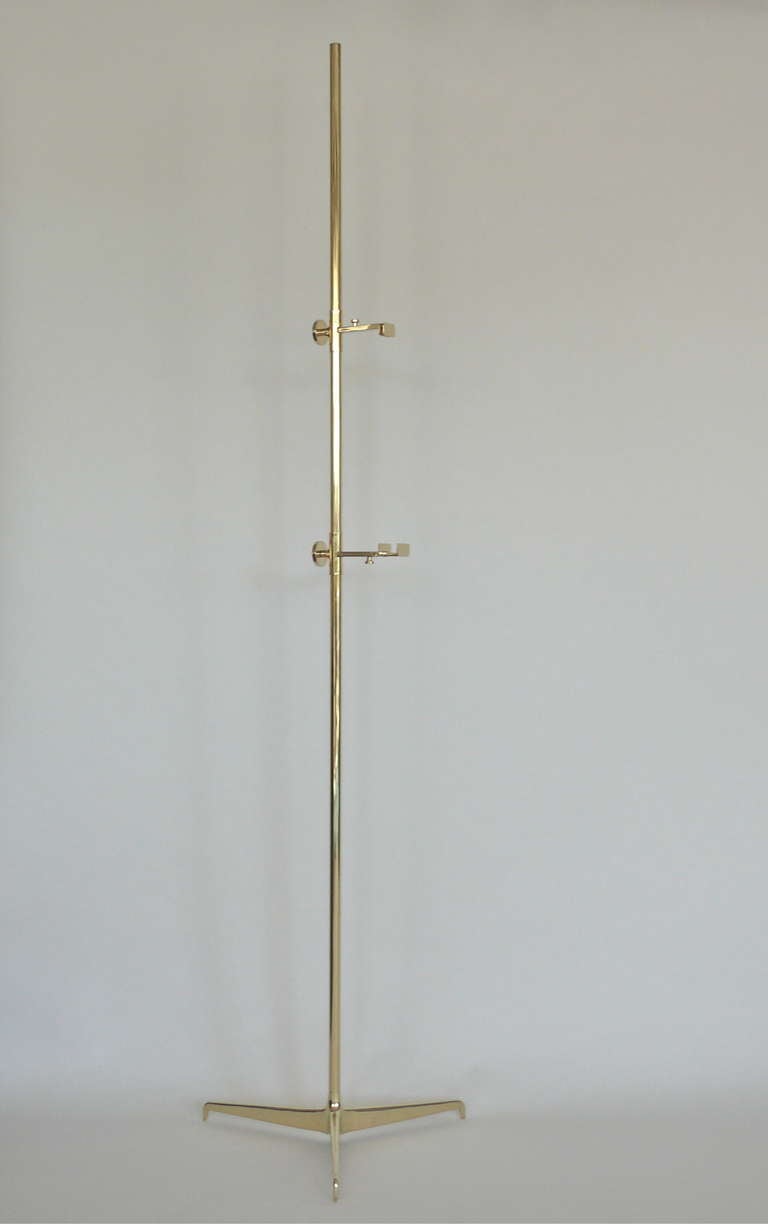 Incredible vintage Italian brass easel with adjustable clamps and tripod base. Clamps easily adjust for various sizes of art. Amazing piece with beautiful lines. Perfect to fill a corner or float in the room.