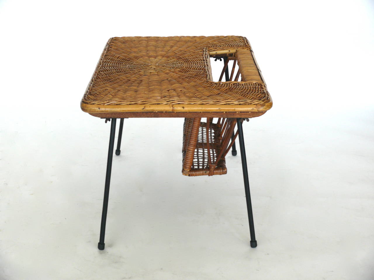 Unique French occasional table with magazine pocket.  Wicker top has a beautiful pattern and sits on a black iron base with rattan trim and pocket for magazines or books.