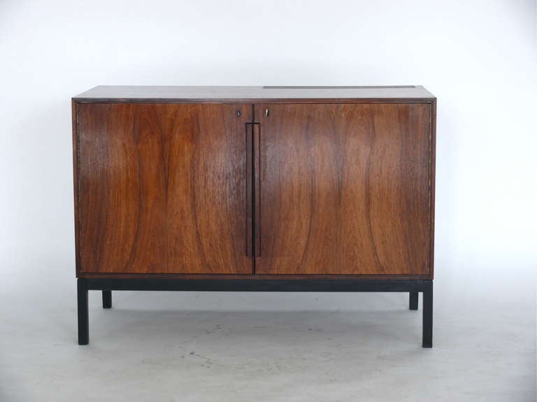 Incredible Danish bar cabinet with small built-in refrigerator by CFC Silkeborg. Rosewood doors open to reveal both storage and shelving as well as a multi-level refrigerator. Great as a bar for a home or office. Original wood finish and working key.
