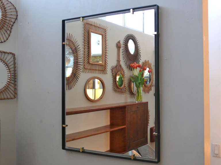 Outlined by a thin steel frame and held in place with solid brass clasps the Trousdale mirror is beautiful in any room.  

Custom sizes and finishes available.

Made in Los Angeles 
