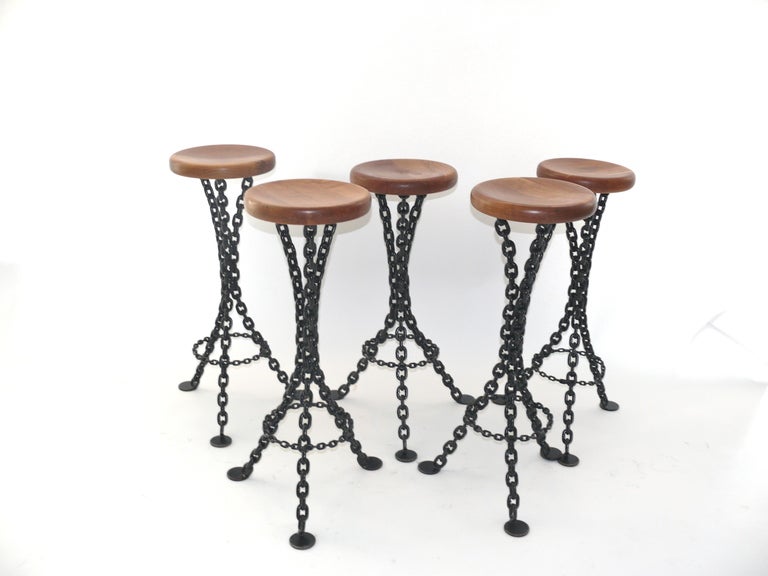 Interesting set of 5 distressed bar stools. Beautiful wood seat sitting on top of black iron chain.  The bar stools are currently 35