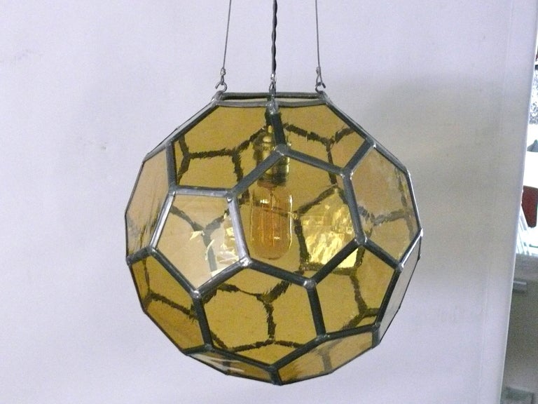 Unique iron and orange glass honeycomb pendant. Interesting geometric hexagon pattern.  Newly re-wired.  Illuminates beautifully.  
Overall Height: 31