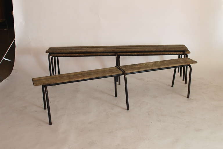 French wood and iron bench.  Slender wood bench is in its original condition with great patina and age. Solid black iron legs with chipped paint support wood slats. 

Seat width is 9 inches