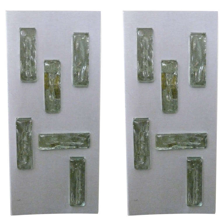 Handsome aluminum and green glass sconces by Jean Perzel. Six pieces of glass arranged in matching geometric pattern. Perfect addition to any powder room or vestibule. Signed Jean Perzel on side of sconce. Newly re-wired. Priced as a pair.