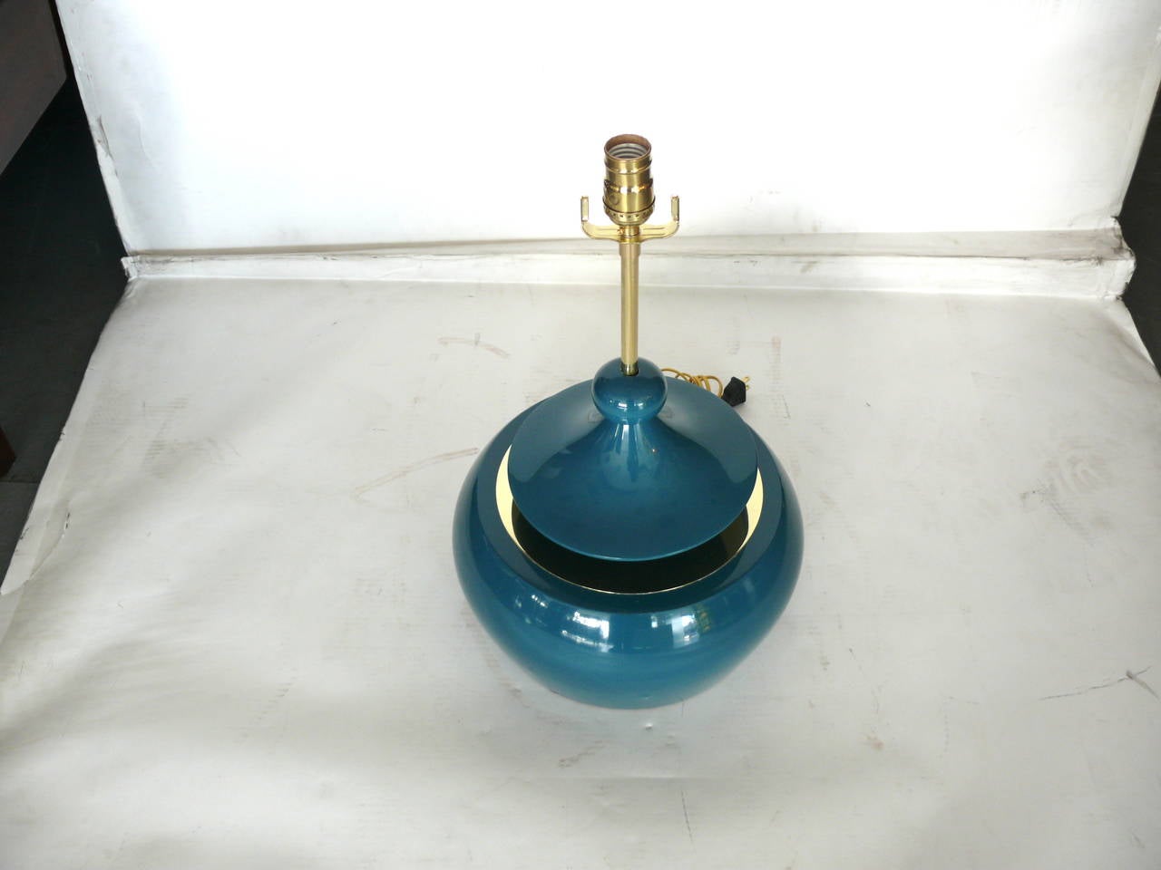 Handsome pair of solid wood table lamps finished in a lacquered teal with brass hardware. Large in scale. Floating wood platform with pull chain on stem allows for a push on and push off light. Newly wired.