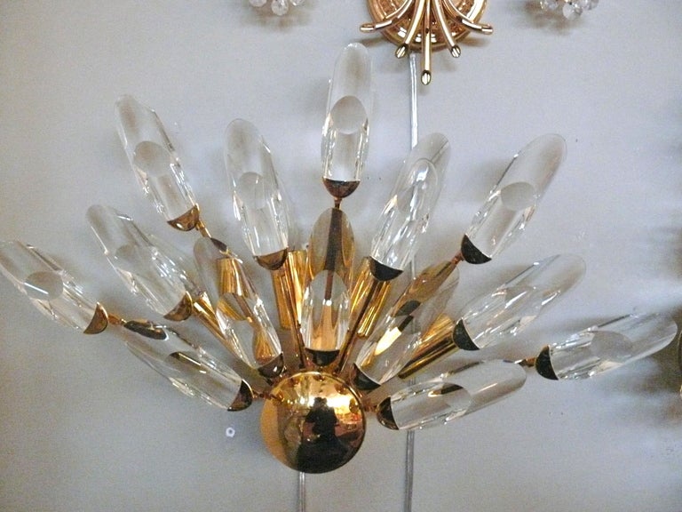 Fantastic pair of Italian glass and brass sconces.  Round brass center with an array of different length pieces of tubed glass capped in brass.  Nice fan shape.  Newly rewired.