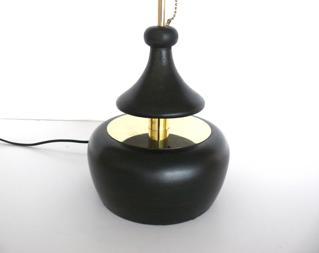 Beautiful pair of solid walnut table lamps refinished in a dark ebony with brass detailing. Floating wood platform with pull chain on stem allows for a push on or push off light. Professionally rewired. Perfect and functional for bedside!