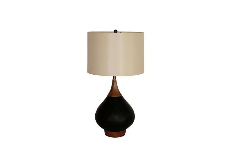 Handsome solid wood and leather lamp. Beautiful teak wood with black leather inlay. Professionally rewired with new silk shade.