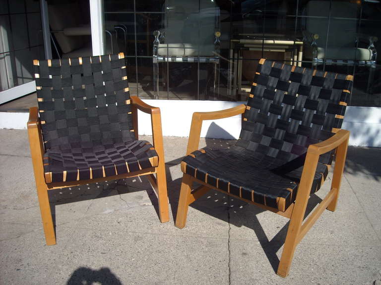 Nice, early pair of armchairs designed  by Jens Risom. They have a vintage strapping maybe from the 80's, but the chairs are from the 50's.