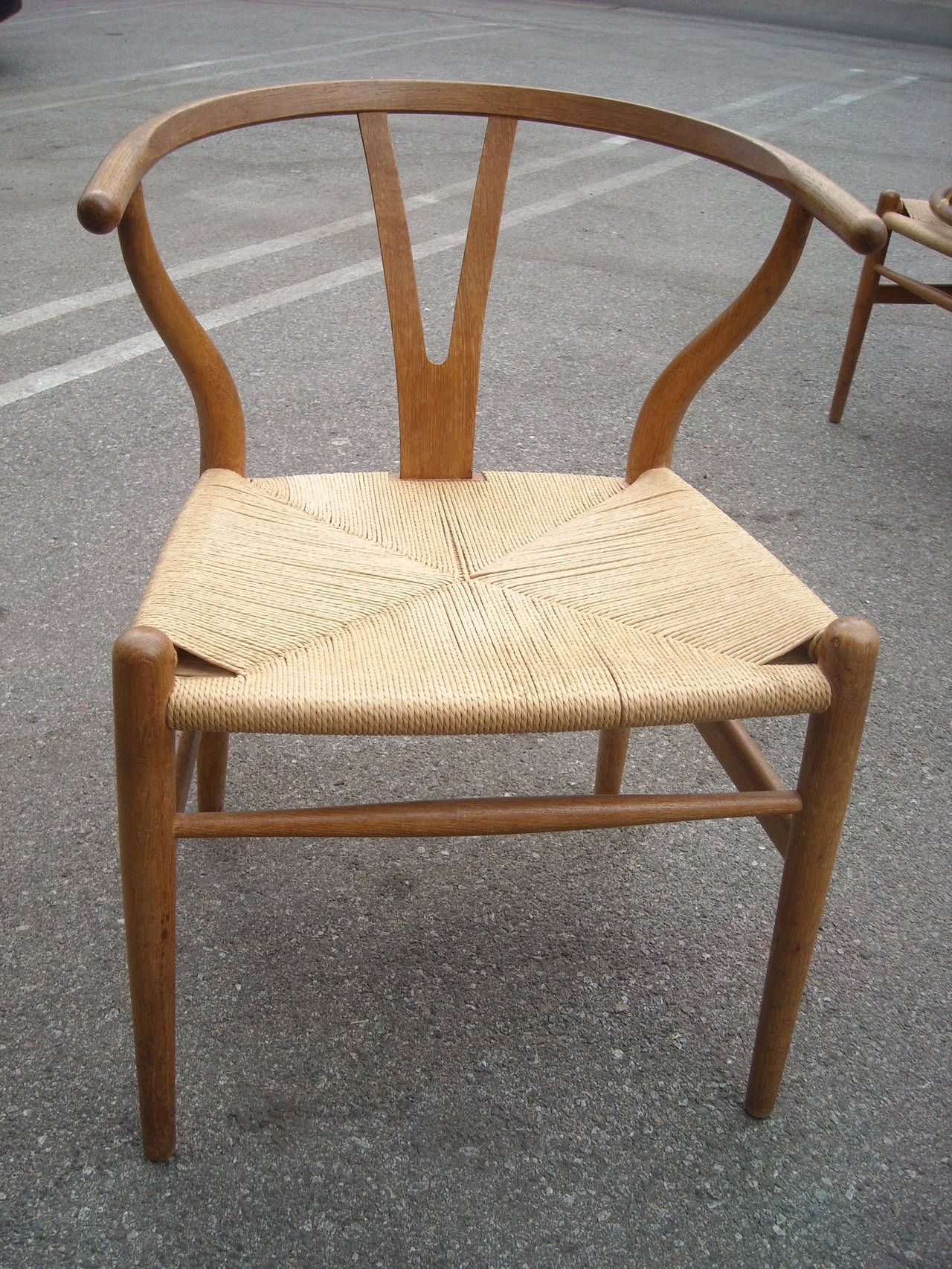 Traditional and well known the Y chair or wishbone in Oak , designed by Hans Wegner. TWO LEFT , SOME REPAIRS 