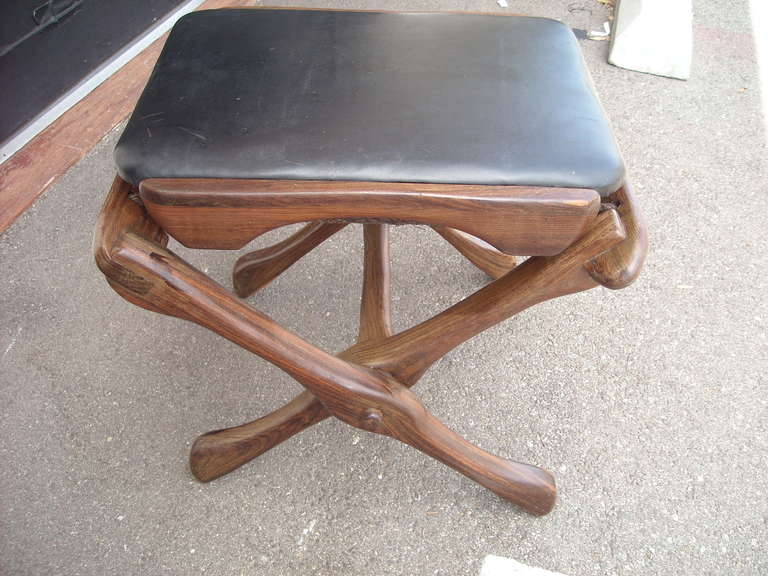 Great stool in rosewood, designed by Don Shoemaker. Suspended seat over leather cord.