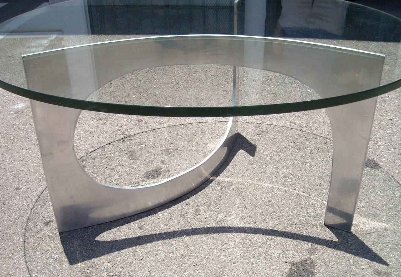 Great brushed aluminum and glass top coffee table. Now the table has a 36 inches glass, but could go much bigger glass.