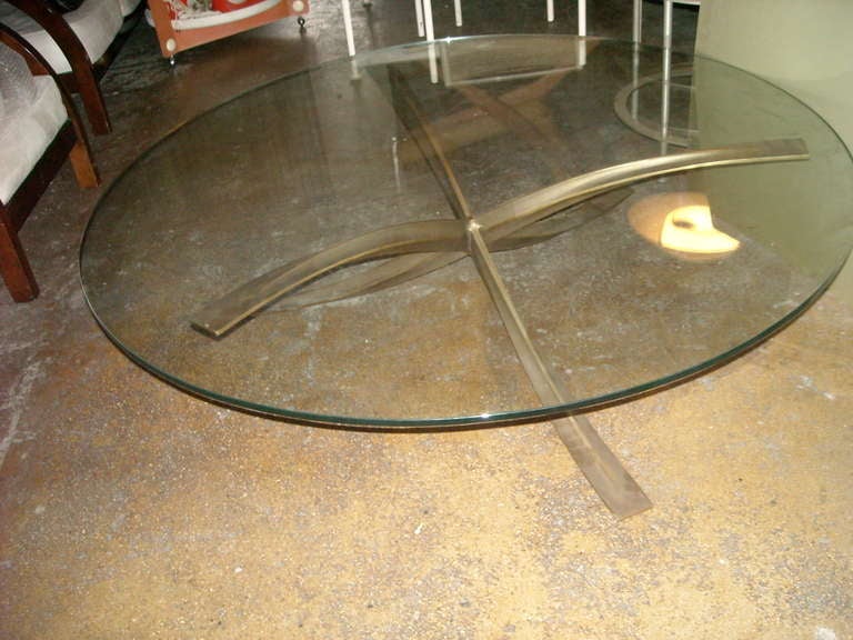 Very nice and elegant design in this bronze base and glass top. Great curved legs and nice soft patina.The bronze diameter is approx 45.5 and high 14 inches. Glass is approx 52 inches diameter.