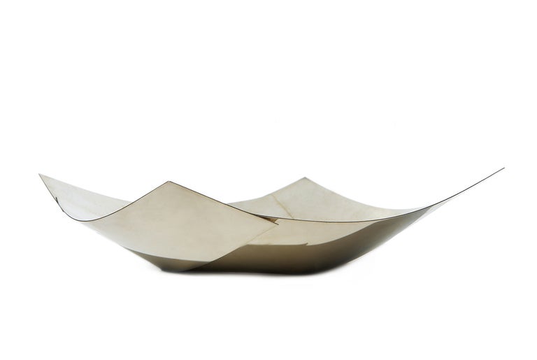 Italian design polymath Bruno Munari (1907 - 1998) designed this bowl for Danese Milano in 1960, and it was produced throughout the 1960s in two sizes (this example is the larger one). Each of these innovative bowls began as a square sheet of nickel