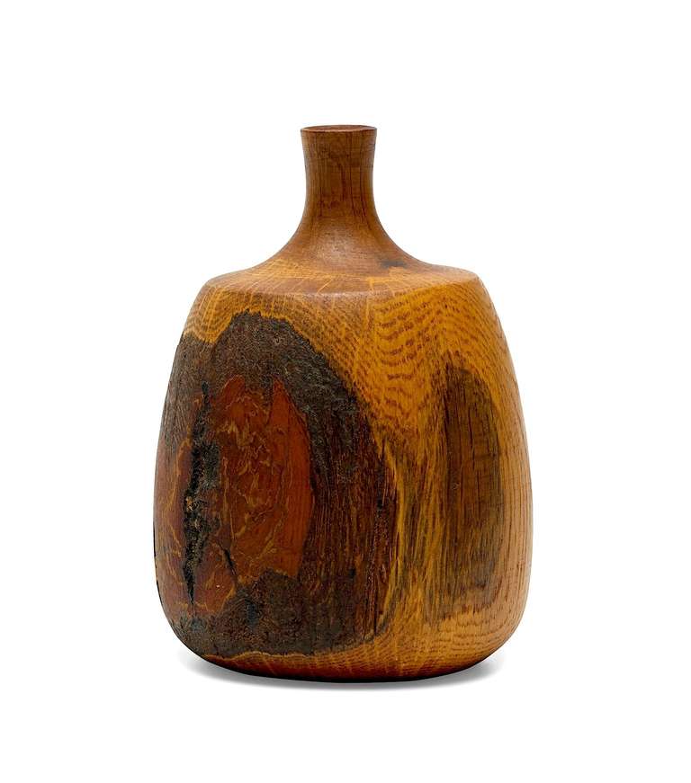 This solid oak vase was handmade by Rude Osolnik, the Mid-Century master of woodturning. Osolnik's work is held in many important collections, and a piece of his was even presented to the Queen of England by the United States government. Signed to