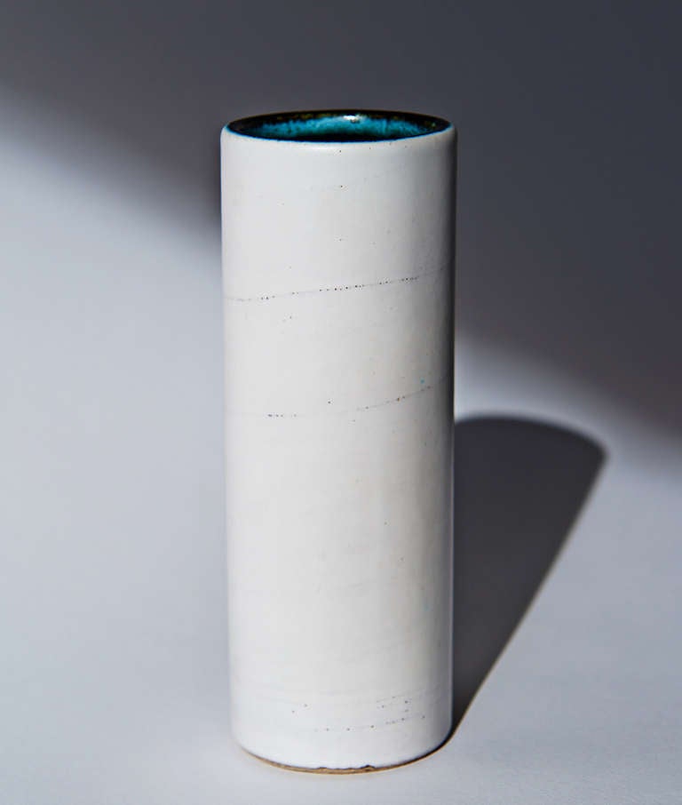 One of Jouve's famous cylinders, in off-white with the subtle glaze effect of a swirl, formed at the periphery of the continuous brushstroke going from top to bottom. Signed with the artist's 