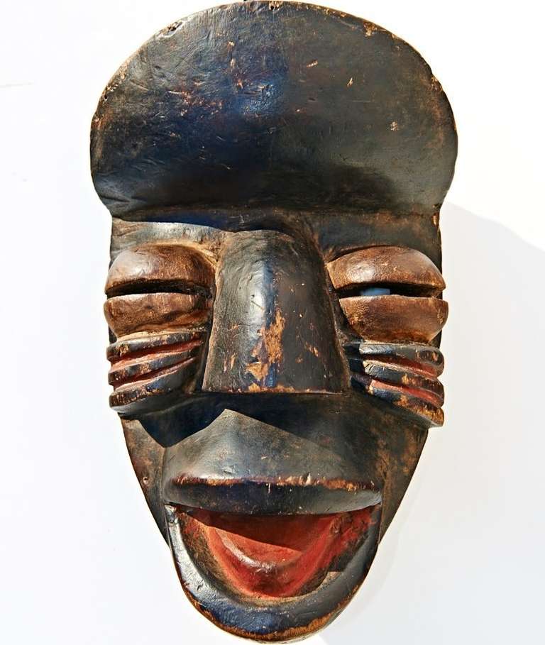 The high domed forehead and exaggerated features are characteristic of the masks of the Nquere people of Cote d'Ivoire. This powerful mask was made many decades ago for use in rituals of initiation -- not to be sold to foreigners.