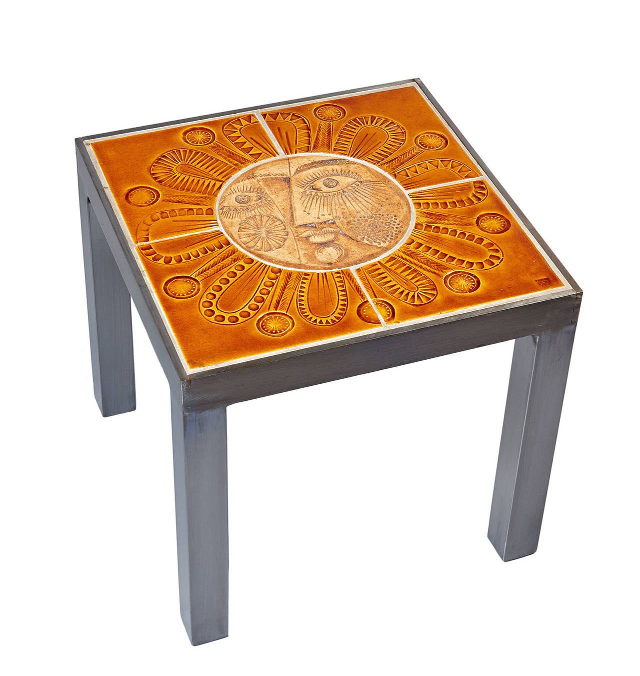 Made during the early 1970s, when the two great Vallauris ceramics returned to collaboration. The table's ceramic top comprises five panels, with impressed decoration. The central panel, a roundel depicting the stylized face of the sun, is unglazed;