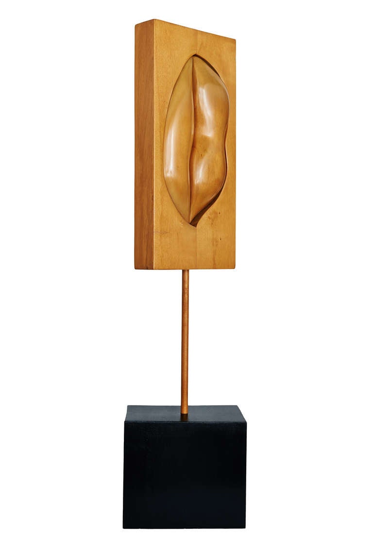 This large sculpture in carved jelutong wood was made to be displayed in several different possible positions (by alternating vertical/horizontal and front/back). Horizontally, the suggestion is of a pair of lips. Vertically, lips of a more intimate