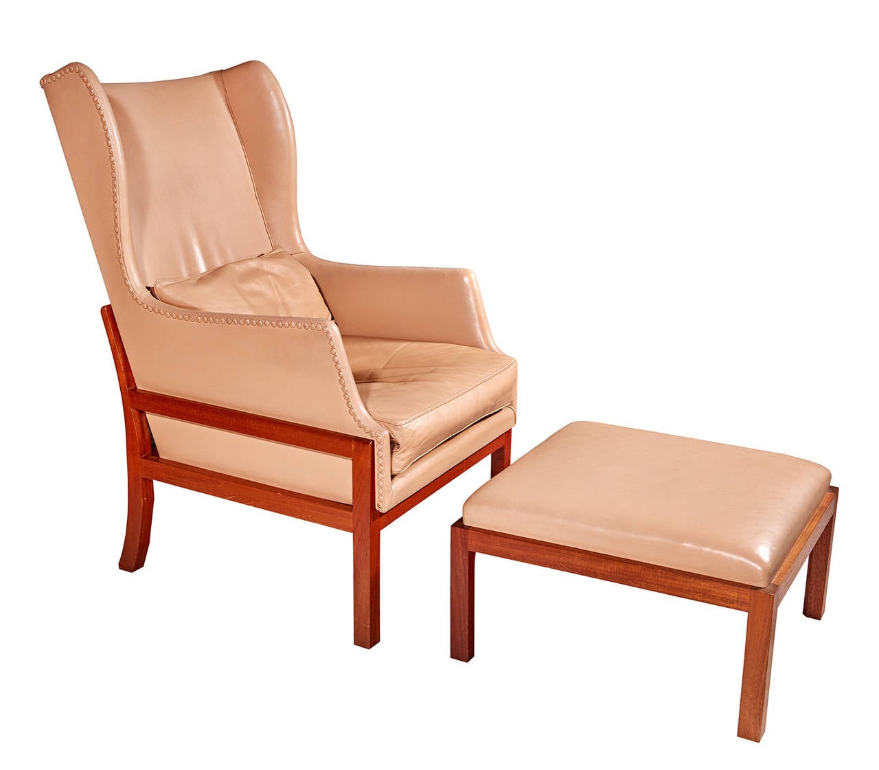 Mogens Koch's magisterial opus, his wingback chair of 1940, was made by Rud Rasmussen from the finest materials: Cuban mahogany and highly finished aniline leather. Handsome, rare, and unostentatiously luxurious, this is one of the greatest of all