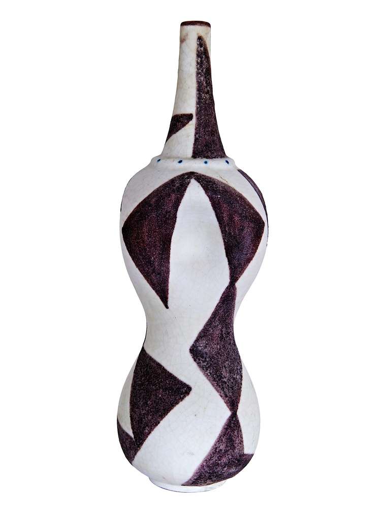 This tall vase is a modified bottle-form, with pinched sides and abstract geometric decoration in Gambone's signature dark eggplant glaze. This piece was actually made to be a lamp-base, with the hole for the wiring modelled and fully glazed (ie,