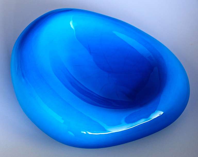 Georges Jouve apparently modelled this freeform bowl after a red blood cell, except in luminous blue. A futuristic and sensual object, more a sculpture than a vessel. Fully signed by the artist.