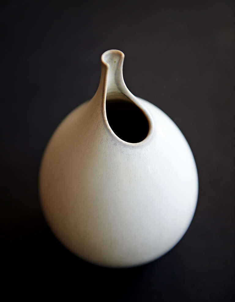 This stoneware studio vase is a signed, unique piece with a close resemblance to the famous production vases (which were cast, not hand-thrown) that their designer, Stig Lindberg, called 
