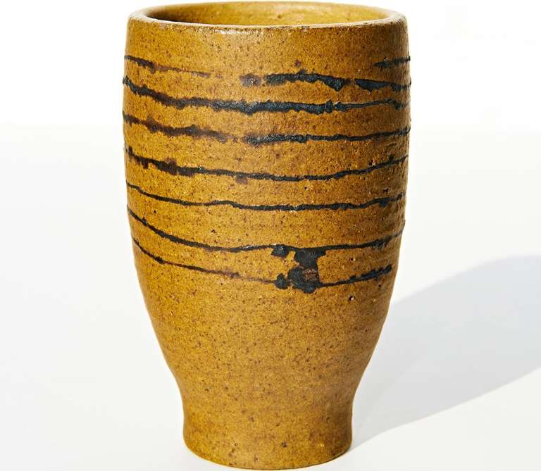 An early vase made in the 1950s. The simple form is decorated by a continuous spiral of slip. Incised signature 