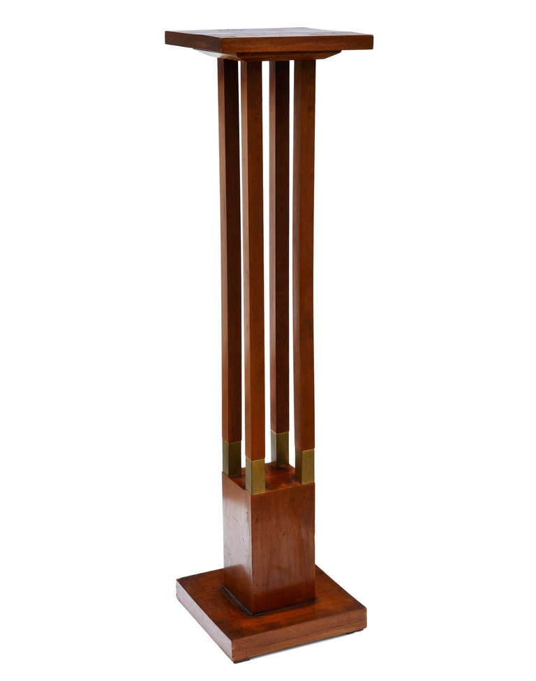 A very handsome wood and brass display stand, somewhat half-way between Frank Lloyd Wright and the Vienna Secession. Of unknown manufacture, it appears to be about 40 years old, and is well made.