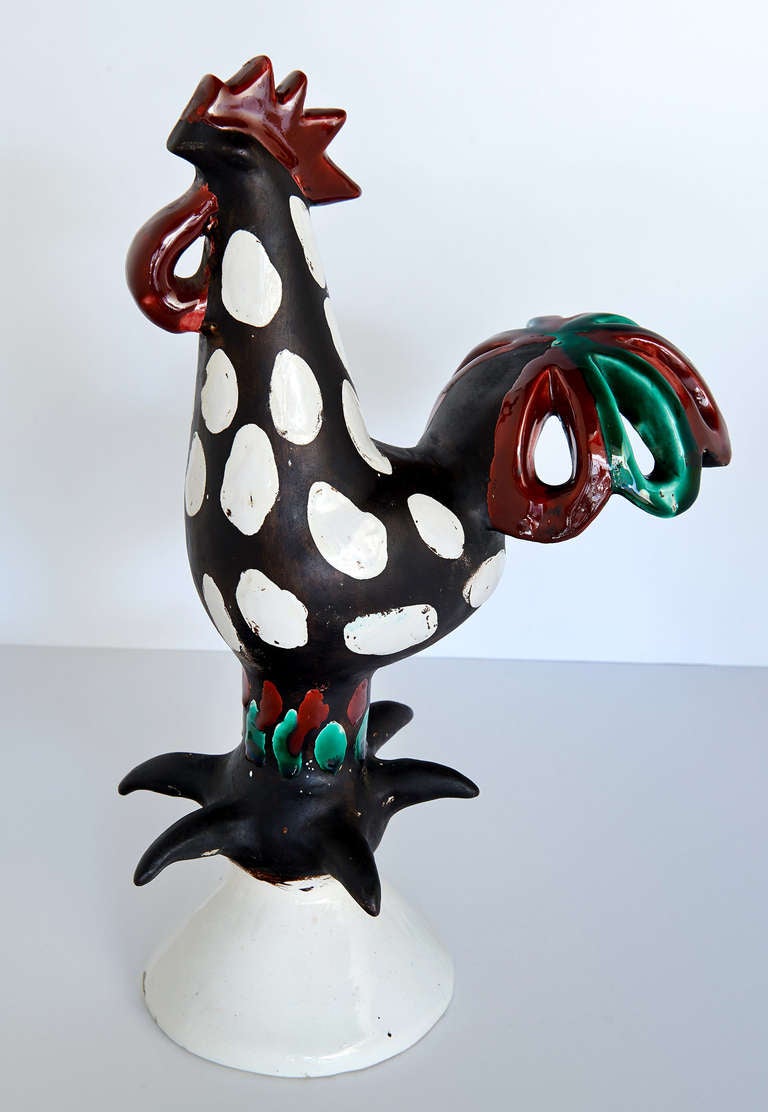 A highly stylized figure of a rooster by the great French ceramist, Roger Capron. Marvelous reduction and development of the familiar forms that make up the body of a rooster. One is particularly drawn to the rendering of the bird's two sets of