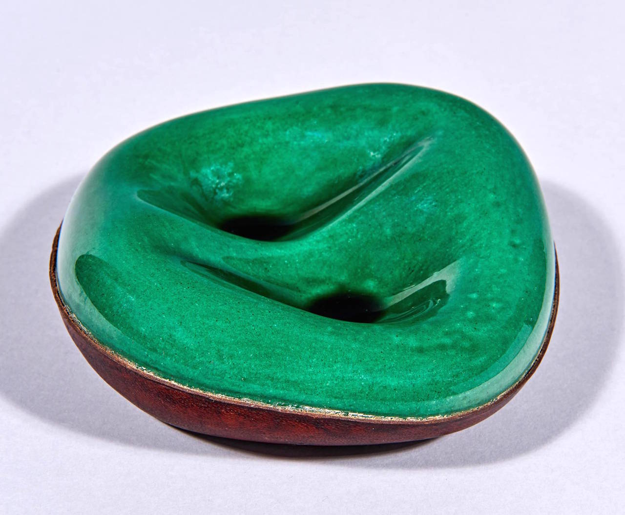 The ceramic part of this biomorphic pipe holder was made by Georges Jouve for Longchamp, who then wrapped the lower portion of the piece in leather. A lovely sculptural object even if you don't smoke a pipe. The leather is stamped 