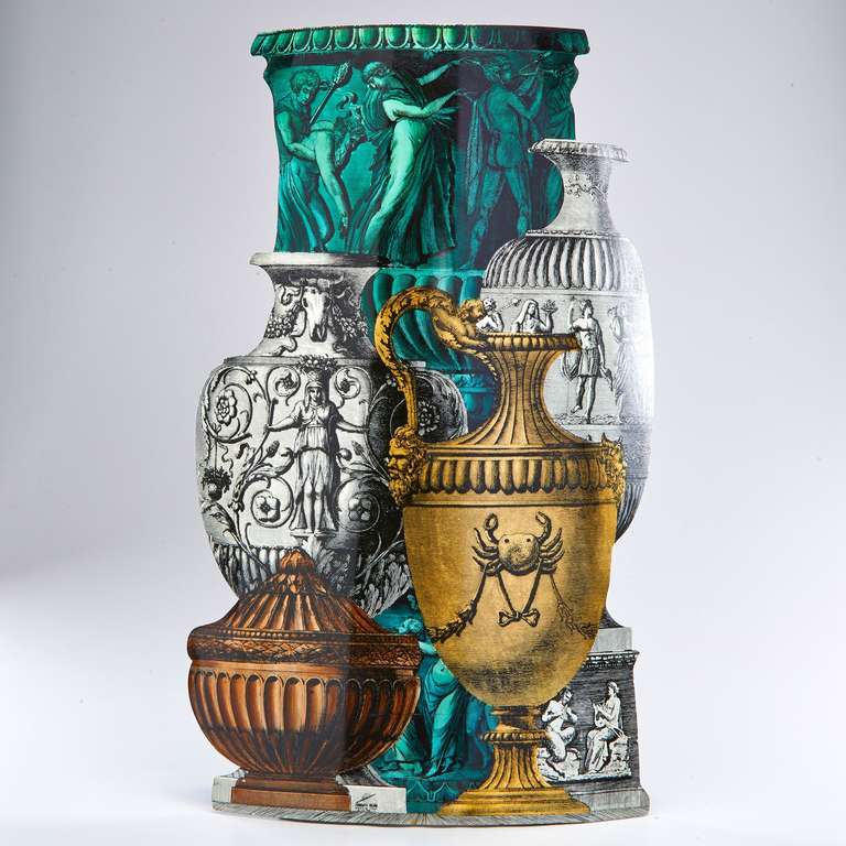 A trompe l'oeil group of classical vases decorates the outer surface of a chic and practical umbrella stand. Designed by Fornasetti in the early 1950s, this example was made more recently. Fully marked.