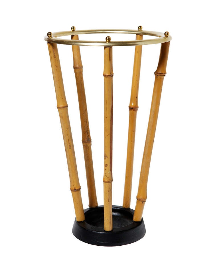 Of unknown manufacture, but reminiscent of the work of Carl Auböck, this delightful umbrella stand is made of bamboo posts sandwiched between a heavy cast iron base, and a brass ring on top secured by internally threaded brass balls.