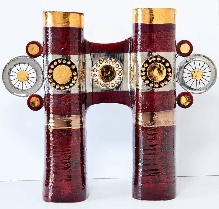 Made by French ceramist Georges Pelletier in the early 1970s, the two columns of this wild ceramic sculpture each conceal a candle. The flickering light of the candles escapes from the backs and tops of the columns, creating a fascinating effect.