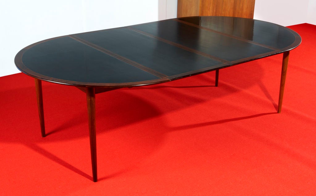 An impressive-looking dining table designed in 1960 by the great female Danish designer Grete Jalk, and made in Denmark by Poul Jeppesen. The frame and legs are made of solid Brazil rosewood, with a top of rosewood and very durable,