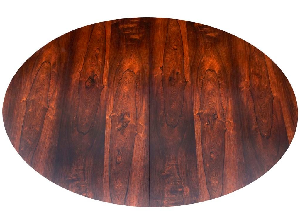 Finn Juhl's finest dining table, made by his greatest collaborator, Niels Vodder, and finished in gorgeously figured Brazil rosewood. Every surface is evidence of Juhl's expressiveness and love of detail, even on parts of the table not normally