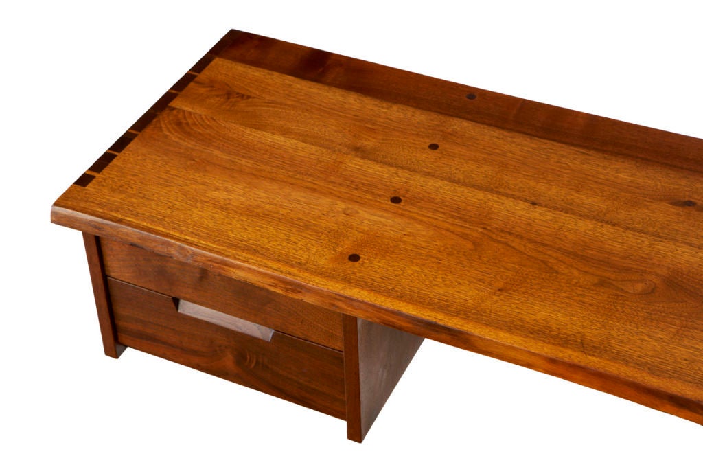 A chic and versatile wall-mounted desk, equally suited for use as a console. The pure quality of Nakashima's joinery is, as it always is, a delight to behold; the two drawers are made with astonishing precision. Also, the walnut on this example is